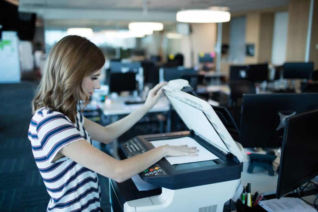 Woman using black and white printers for small business