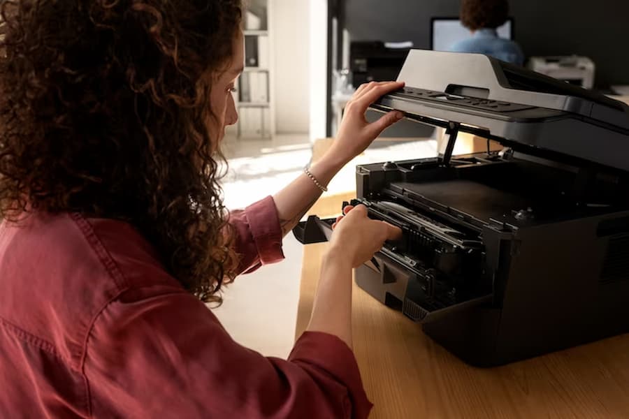 Woman is doing to empty Printers Waste Cartridge Full
