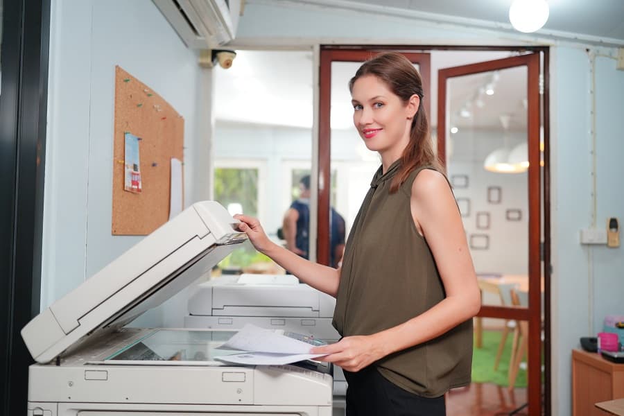 Woman is checking copier to know value and How Much Is Copy Machine