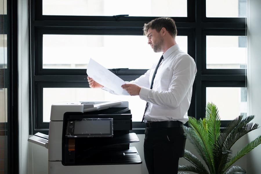 Man is reading copier Service Agreements