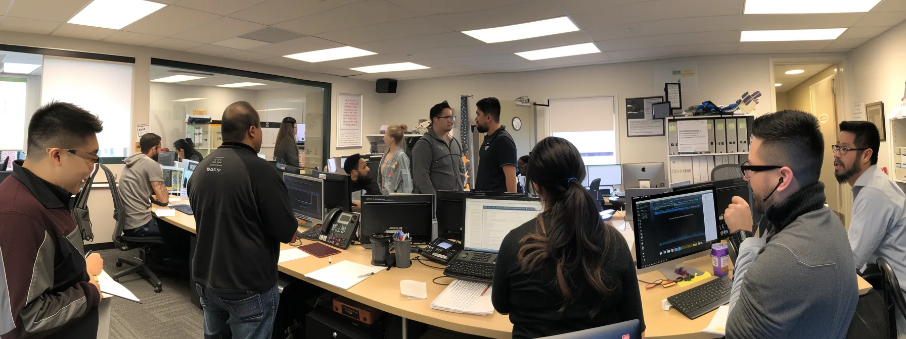 a busy office with employees engaging in a hands-on training session to seamlessly integrate a new phone system, showcasing teamwork and productivity.