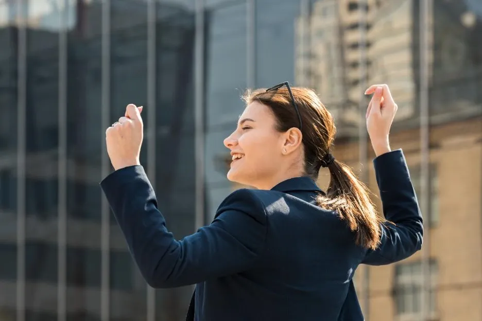 Steps to Building a Strong Academic Foundation for Career Success 13 a woman with her arms up in the air