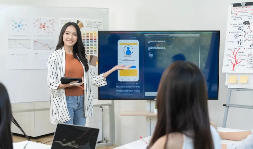 How Digital Whiteboards Help Students Brainstorm Like Professionals 13 a woman pointing at a digital whiteboard