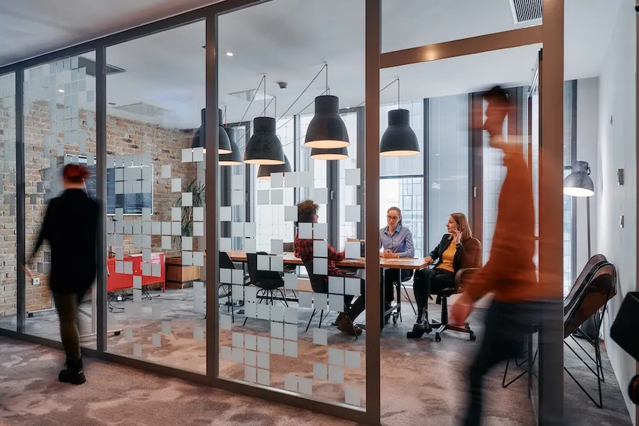 people in a room with glass walls