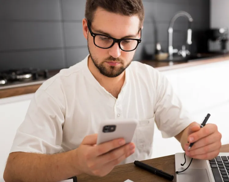 man using mobile doc management kitchen