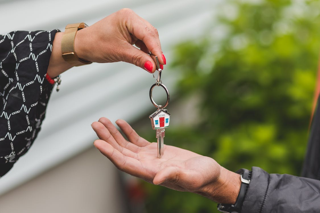 Person holding a key representing rental access