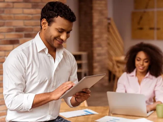 A colleague pulling up a document on a tablet