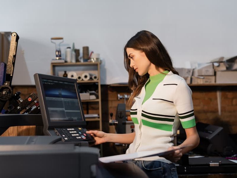 Woman is Checking Commercial Printers Print Quality Commercial managed print services