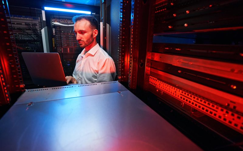 Data center administrator inspecting server rack software